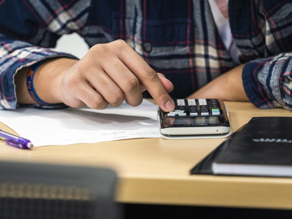 Student in a math class using a calculator