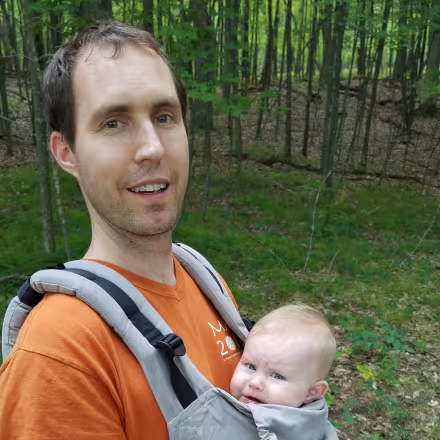 Dillon Carr holding his child