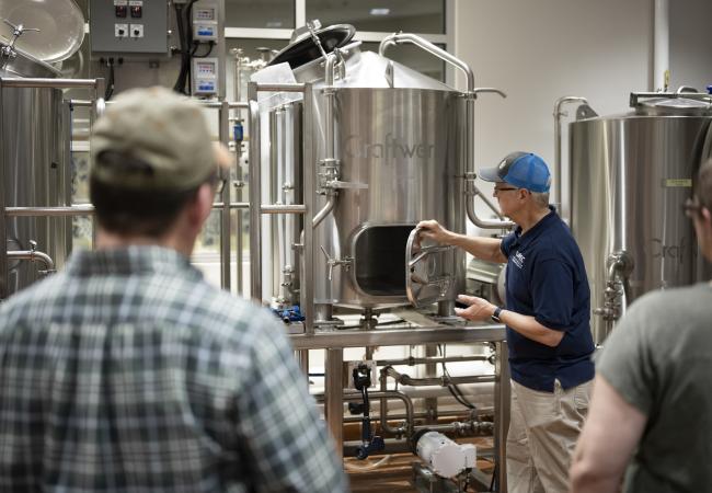 Craft brew students working in the distillery