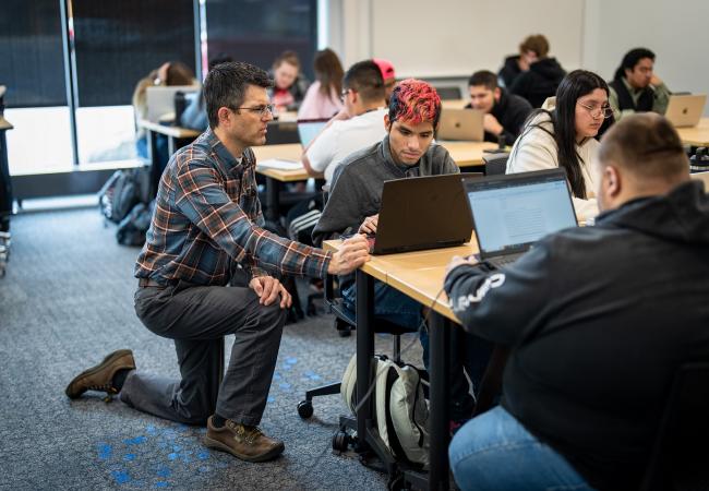 Students working on laptops in a classroom