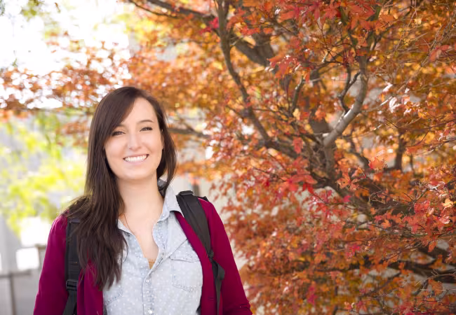 Student outside in the fall