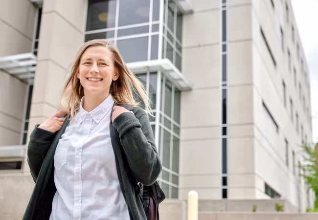 Student outside of the science building