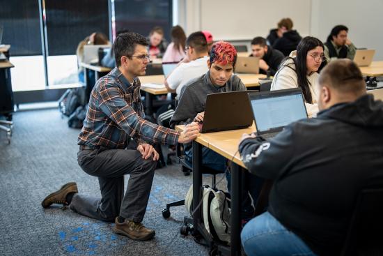 Students working on laptops in a classroom
