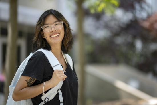 Student outside the learning center carrying a backpack