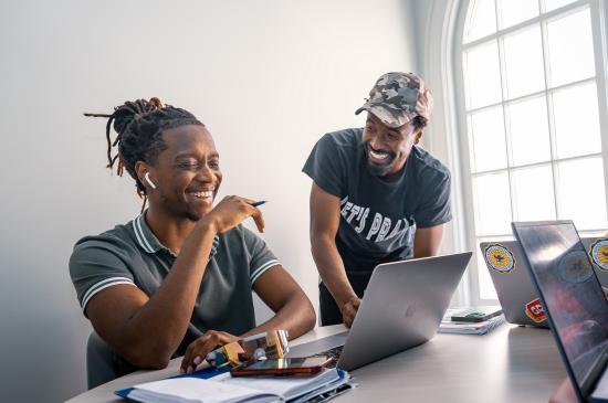 Students working on laptops in a classroom