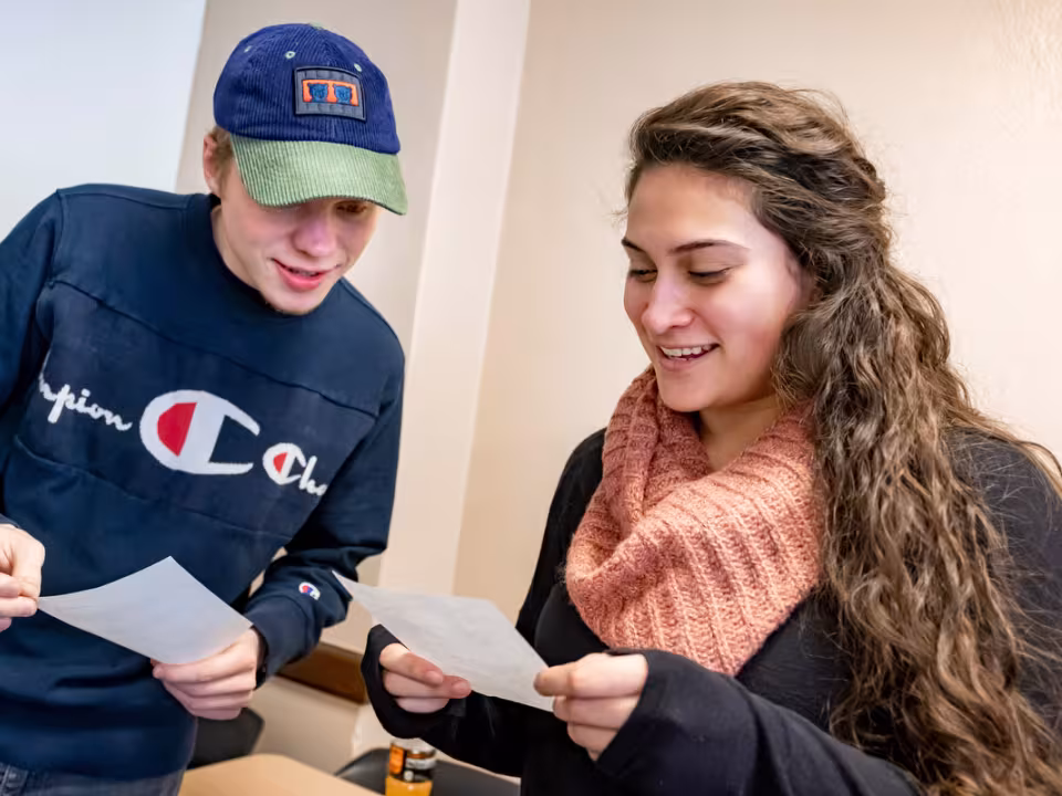 Two students reviewing papers