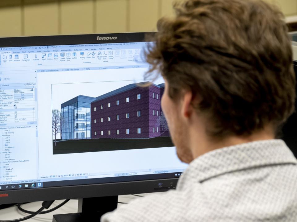 A student designing a building on a computer