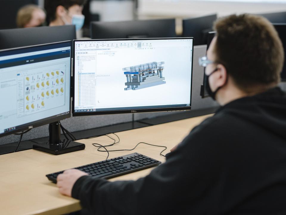 A student uses architectural design software to create schematics and blue prints.