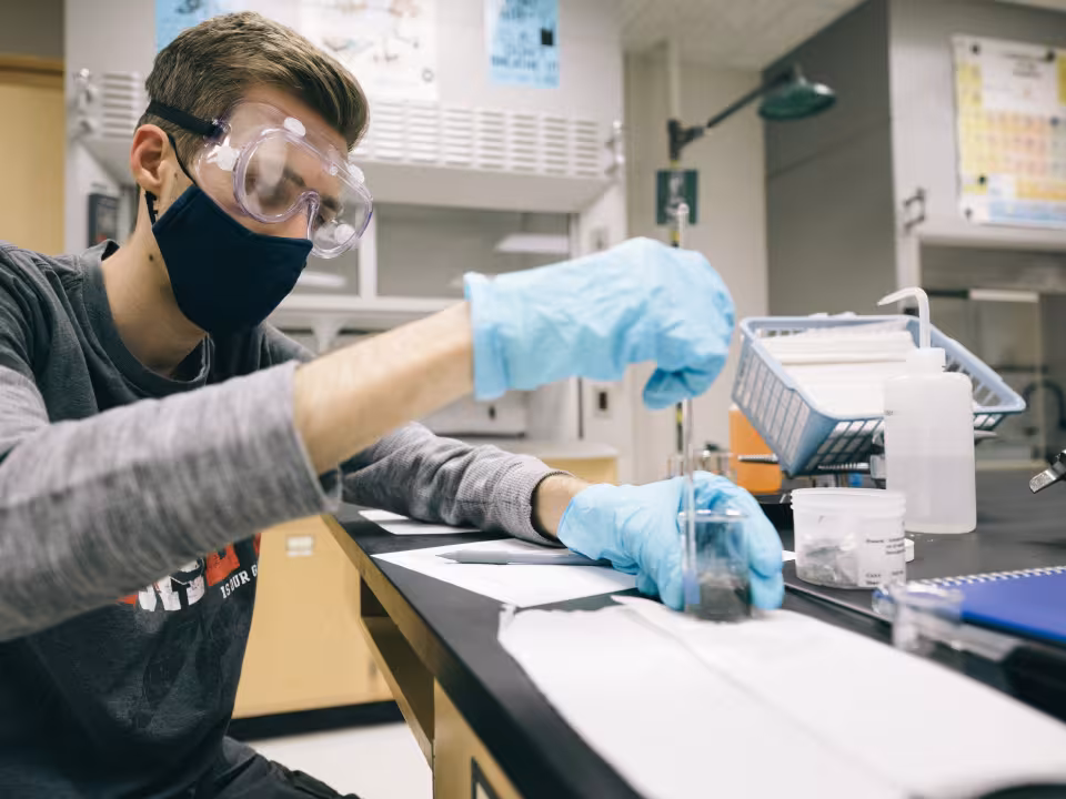 Student using a dropper in a biology lab class