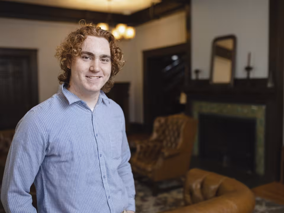 Student smiling in white hall 