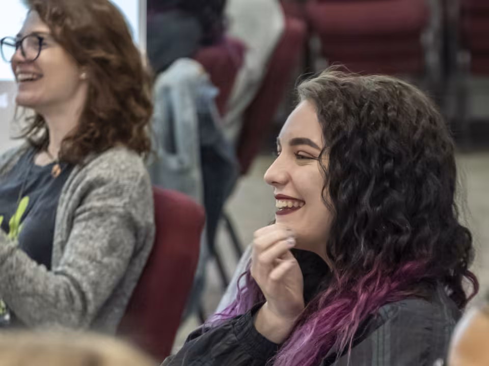 Student laughing while watching other theater students