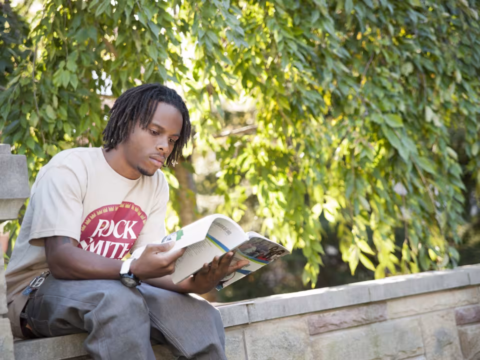 Student studying outside on the commons
