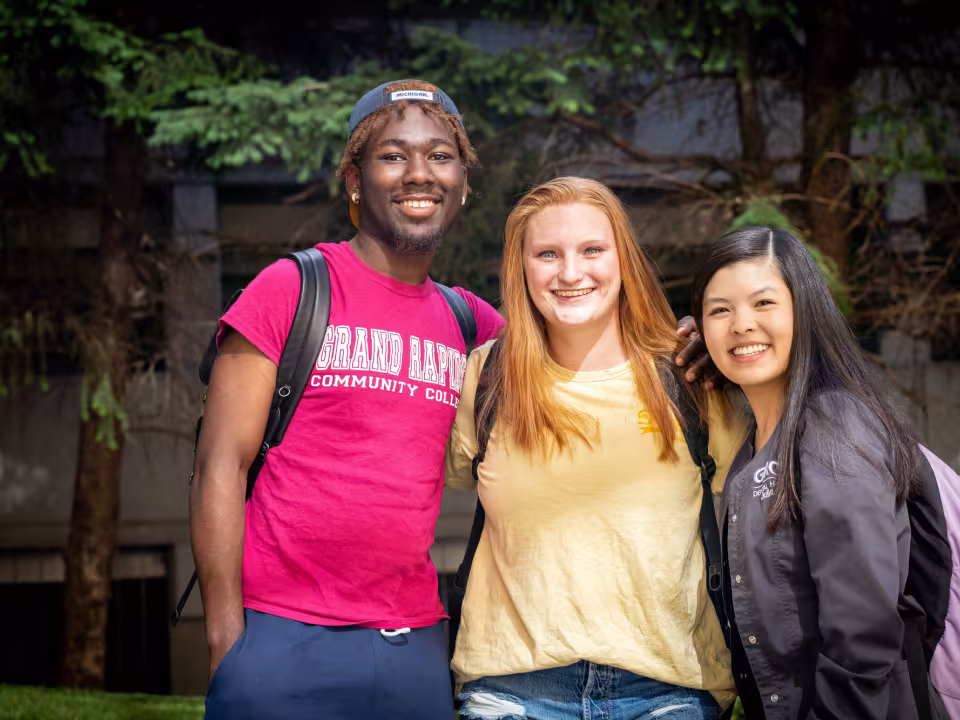 Three students pose for a photo.