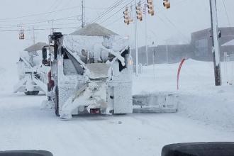Snow plow covered in ice