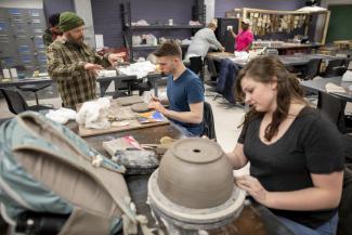 GRCC student making a bowl in a pottery class