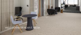 Media West Corridor near IT Media featuring a variety of seating and glass-windowed offices with curtains.
