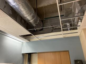 With drop ceiling tiles removed, duct work is visible.