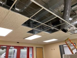 With drop ceiling tiles removed, duct work is visible.