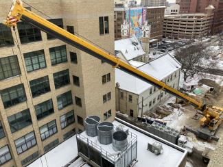 A construction crane outside Raleigh J. Finkelstein Hall.