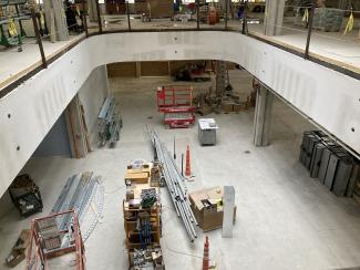 A second-story interior balcony view looking down to the first floor.