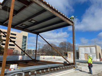 A person observes the penthouse frame and roof.