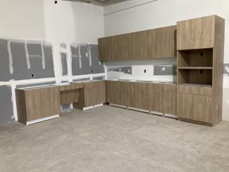 Cabinetry installed in an unfinished room.
