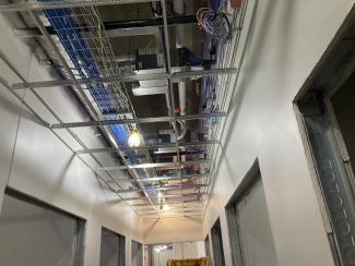Data cables run in an unfinished ceiling.