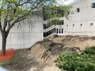 Sitework demolition of hillside and walkway.