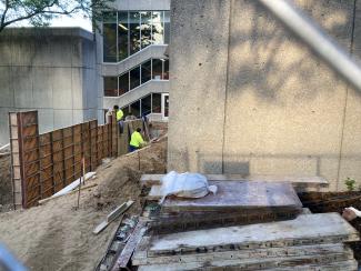 Workers are working to remove the heavy forms from the retaining walls.
