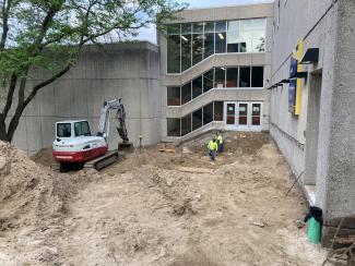 Workers setting forms for the pier footing and one retaining wall.