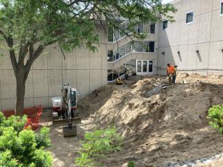 Workers guiding concrete into the forms.