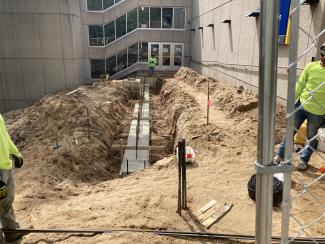 The first cement pour goes into the footing forms for the retaining walls.