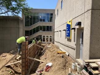Workers set heavy forms on footing the the second concrete pour