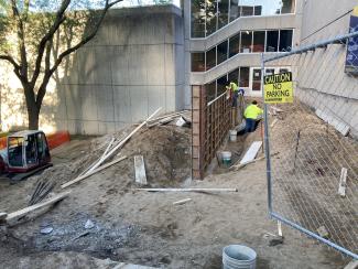 Concrete has dried overnight and workers are removing the forms.
