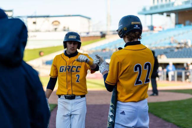 Baseball players fist bump after a nice play.