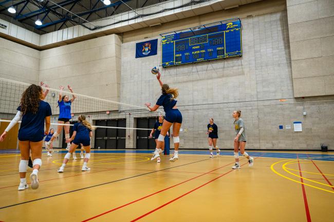 GRCC volleyball players in action.