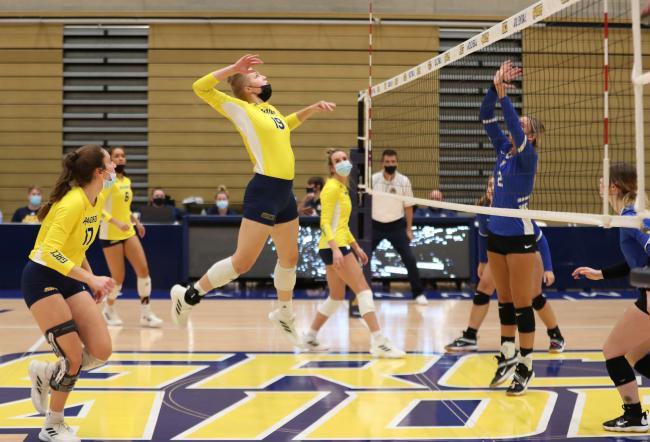 Alena jumping to strike the ball. 