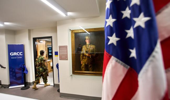 A veteran passing the Mathias Alten portrait at the GRCC Veterans Center.