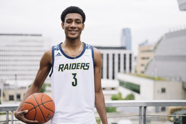 Andrew Moore posing with a basketball.