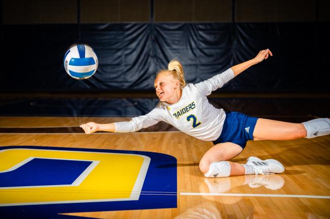 Audrey Gower diving for a ball.