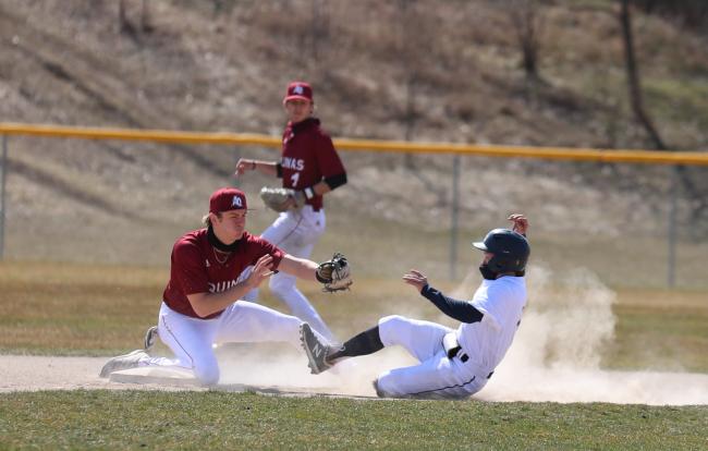 A GRCC Raider sliding into second base.