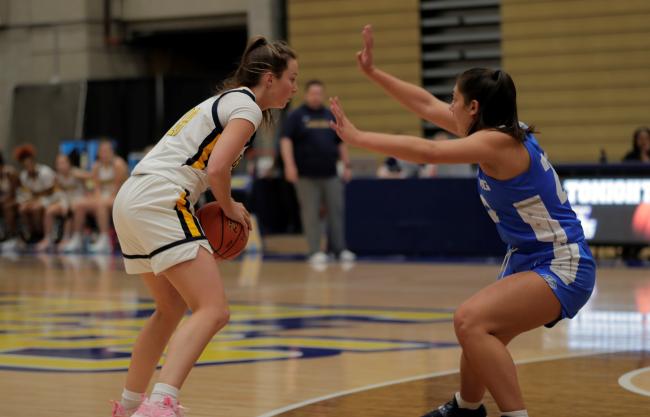Basketball player trying to get around a defender.