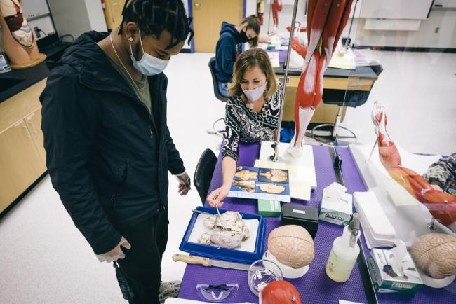 Biology professor Leigh Kleinert working with a student in a lab.