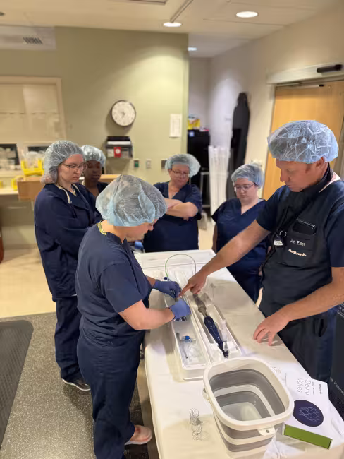 GRCC cardiovascular technology students dressed in scrubs learn about medical equipment.