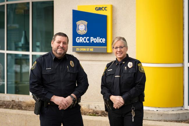 Two GRCC campus police officers stand near the GRCC Police office