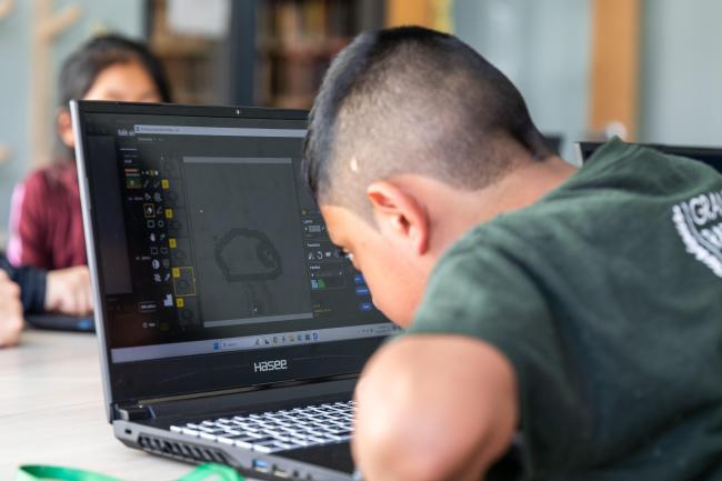 A child works on a computer.