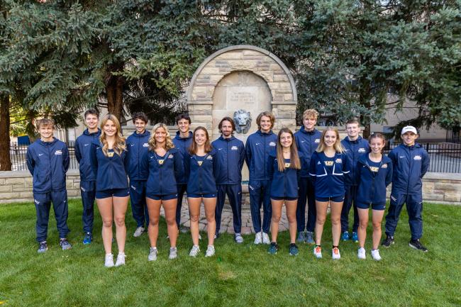 Cross country teams posing together at GRCC's iconic lion fountain. 