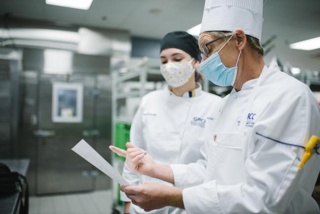 Chef Bob Schultz working with a student.