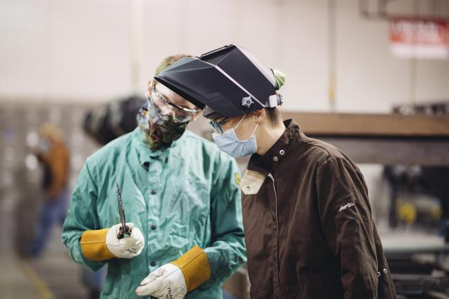Two Metallica Scholars students wearing protective equipment