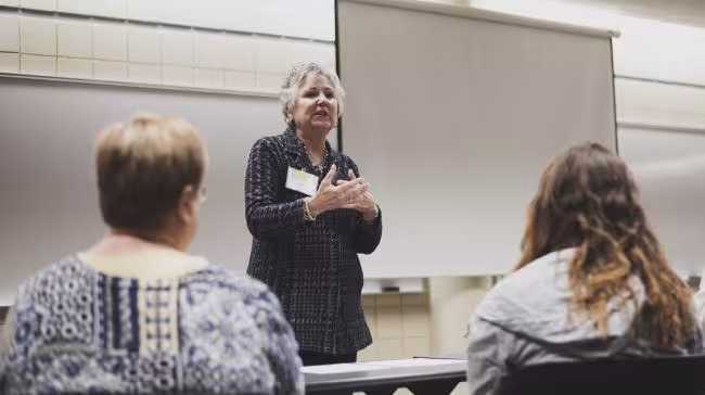 Former trustee Deb Bailey leading an discussion.